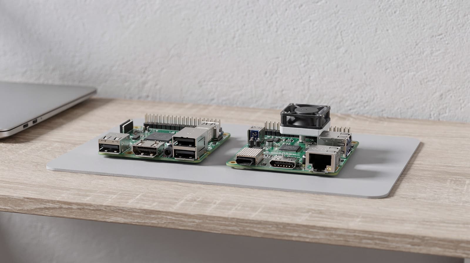 Two single-board computers side by side, one with a cooling fan