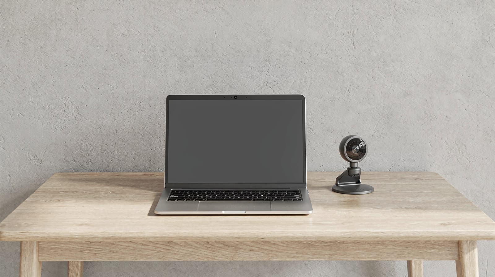 Laptop with a built-in camera next to an external desktop webcam